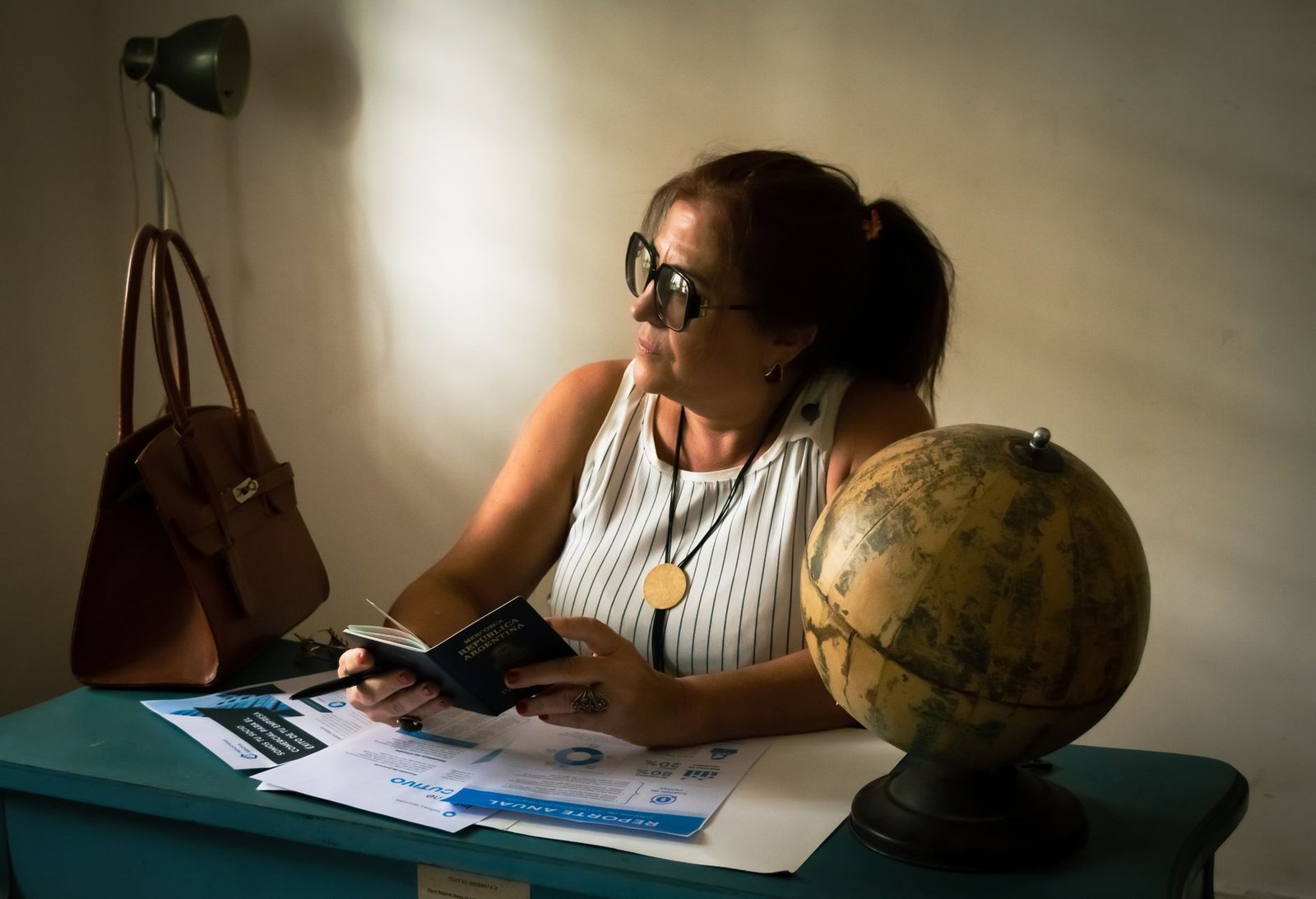 Veteran holding a passport alongside documents related to VA disability benefits overseas