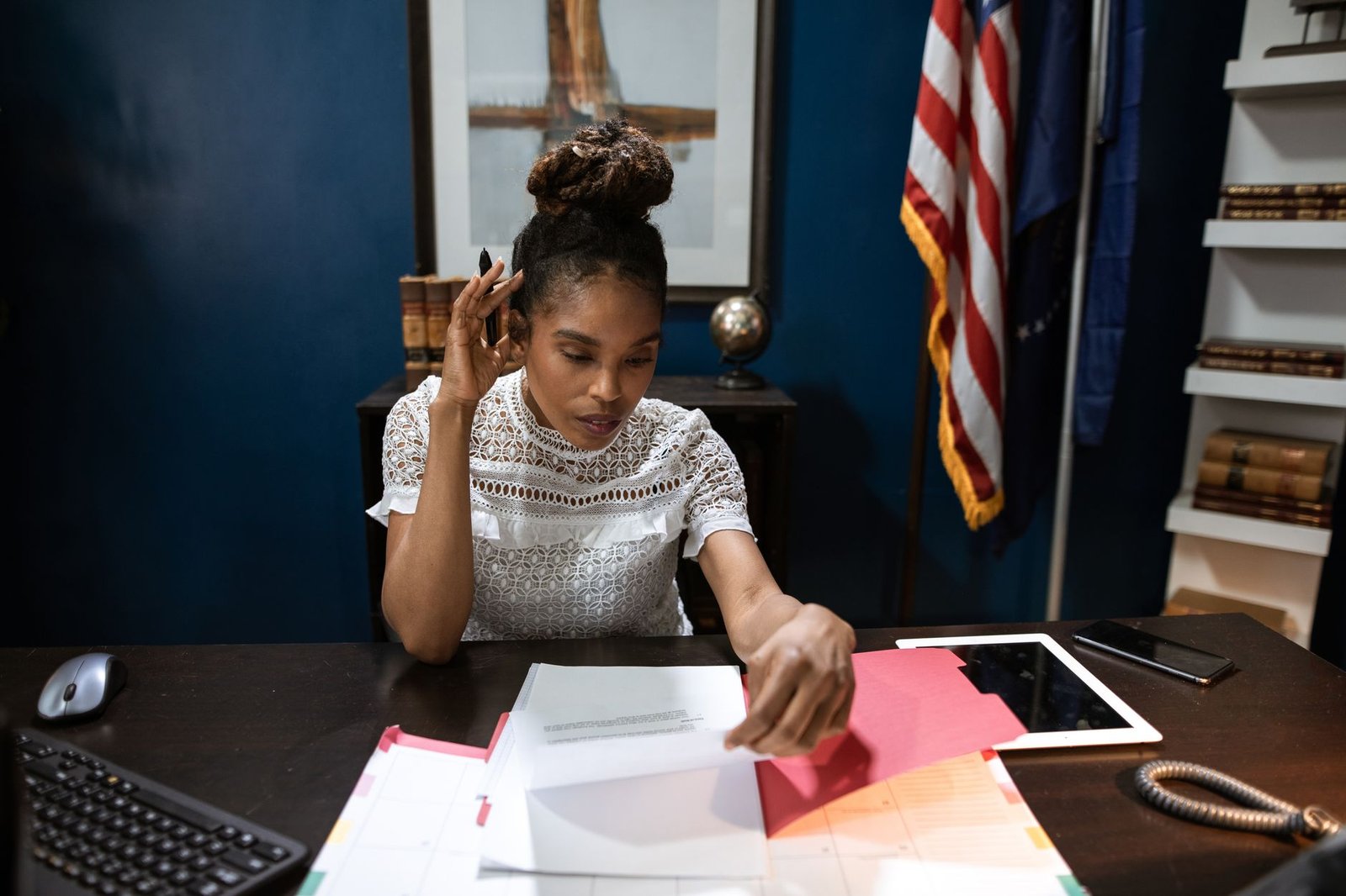Surviving spouse preparing the VA Form 21P-534EZ survivor application at her kitchen table