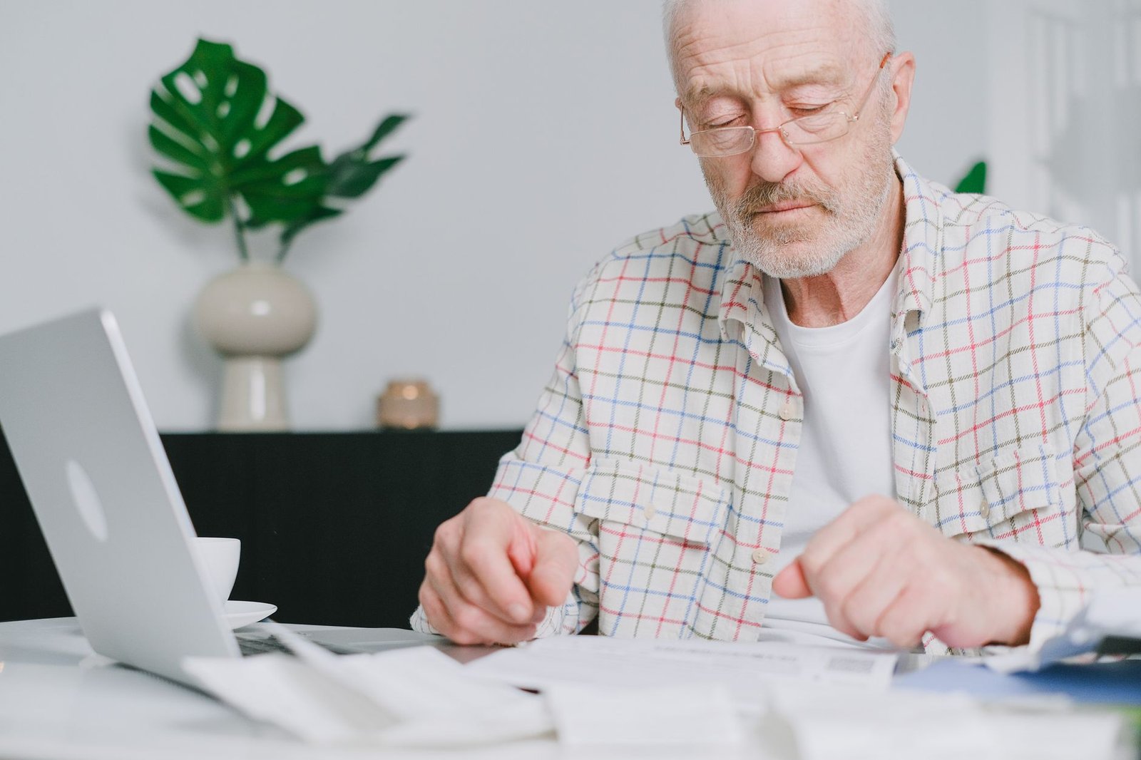 Veteran reviewing paperwork related to military medical retirement and VA disability at home