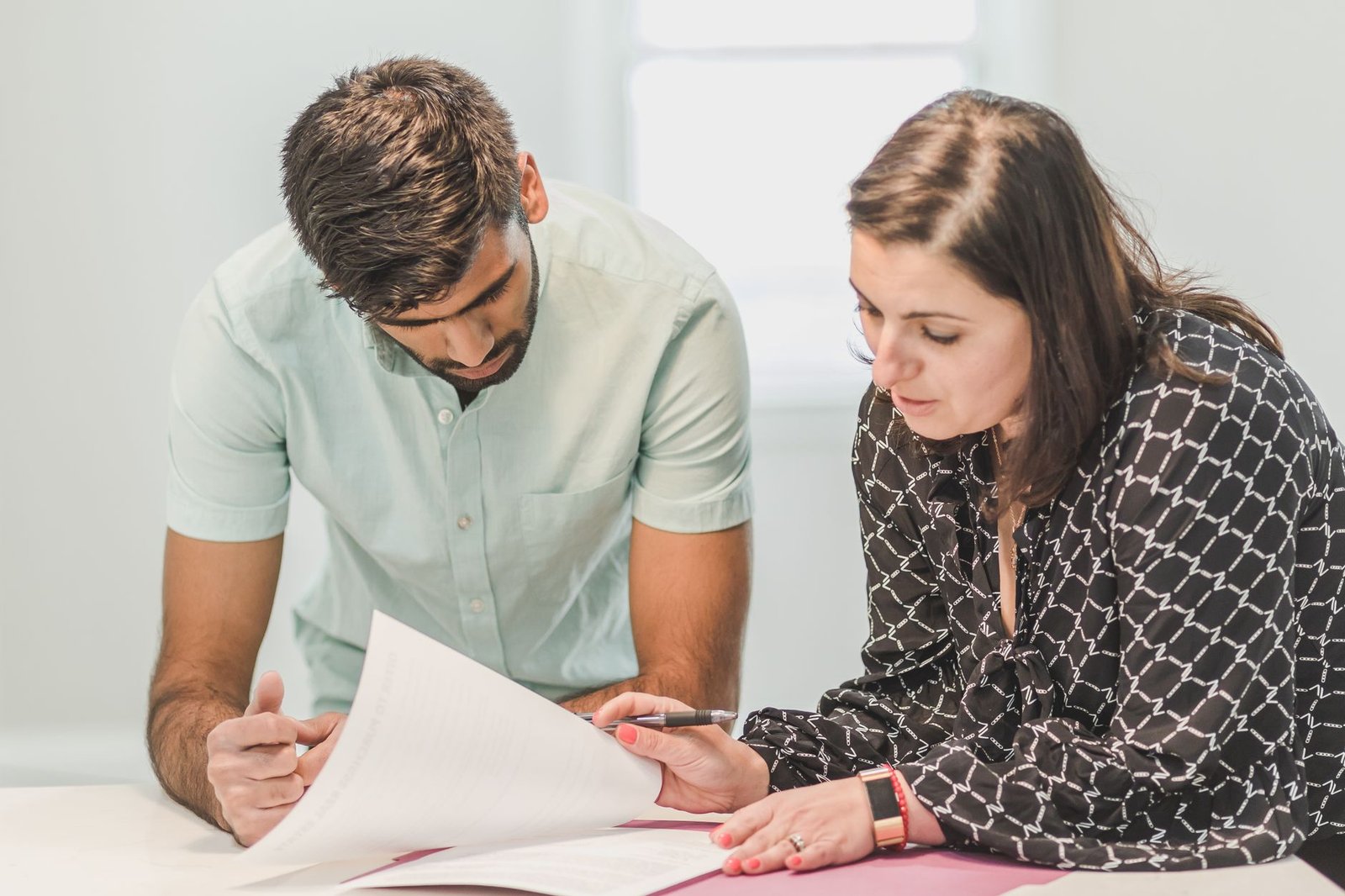 Veterans Service Officer reviewing a VA Form 21P-534EZ survivor application with a family member