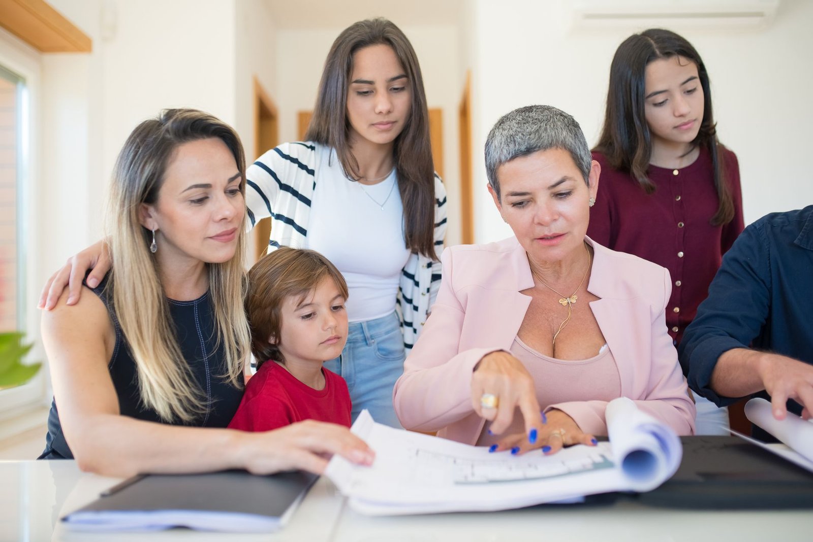 Family reviewing paperwork at home while requesting a Presidential Memorial Certificate for a late veteran
